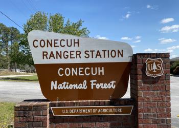 Brown and white Conecuh Ranger Station sign in the Conecuh National Forest 